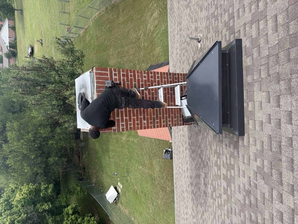 Texan Flue technician repairing and resealing a chimney cap on a DFW rooftop