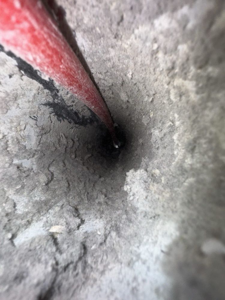 Professional rotary rods cleaning creosote from a chimney flue in North Texas