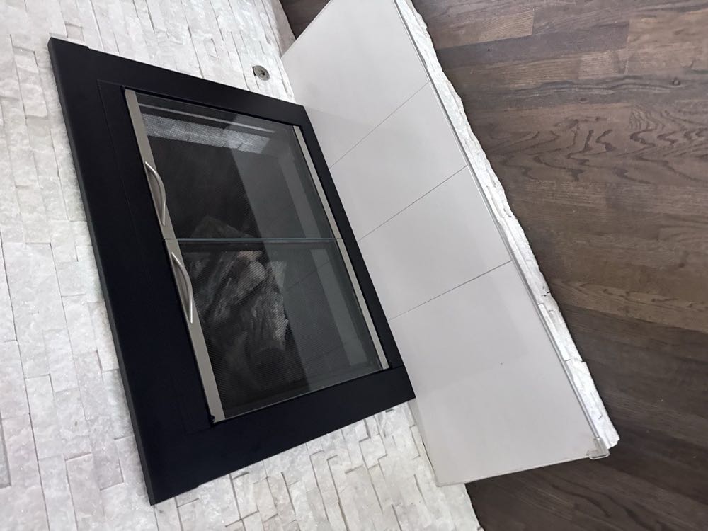 Gas log fireplace with clean white surround installed in a Dallas–Fort Worth home