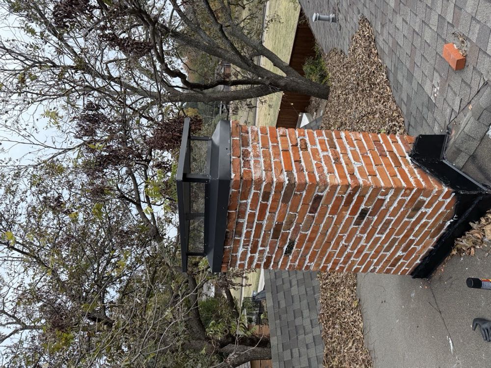 Top-sealing damper and cap assembly installed at the top of a brick chimney flue in DFW