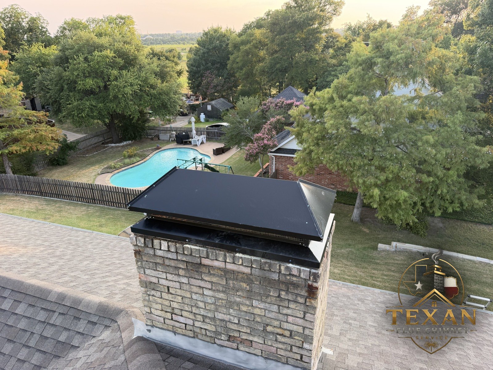 Custom black full-coverage chase cover freshly installed over a Dallas–Fort Worth estate — Texan Flue