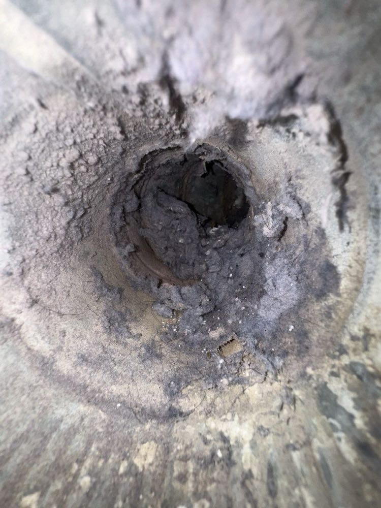 Soot-blackened smoke chamber above a Dallas firebox before chemical cleaning